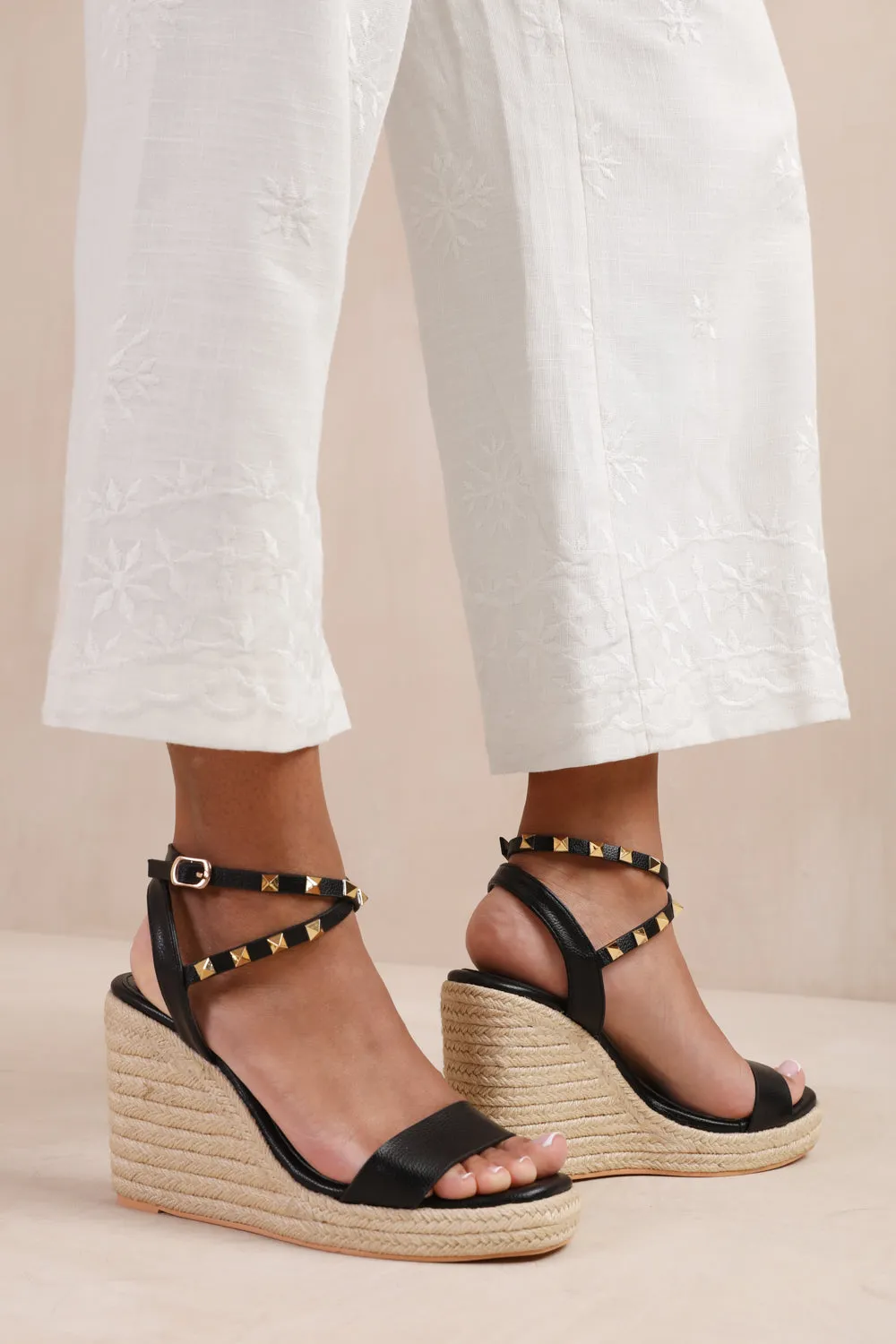 TEXAS WIDE FIT CROSS OVER ANKLE STRAP WITH STUDD DETAIL ESPADRILLE WEDGES IN BLACK FAUX LEATHER