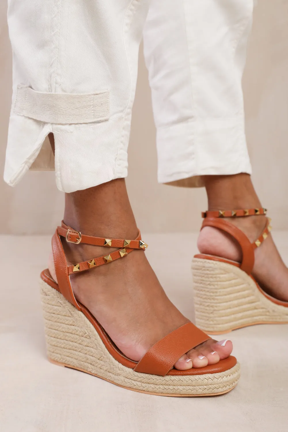 TEXAS WIDE FIT CROSS OVER ANKLE STRAP WITH STUDD DETAIL ESPADRILLE WEDGES IN TAN FAUX LEATHER