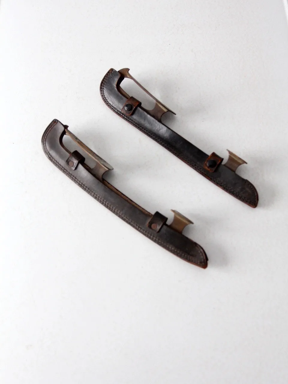 vintage ice blades with leather covers