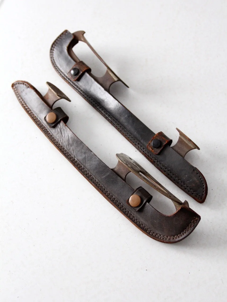 vintage ice blades with leather covers